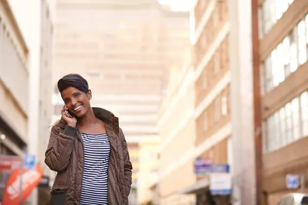 Phone call, smile and black woman in a city, conversation and New York with communication and network. Person, outdoor or girl with happiness or walking with cellphone and digital app with connection.