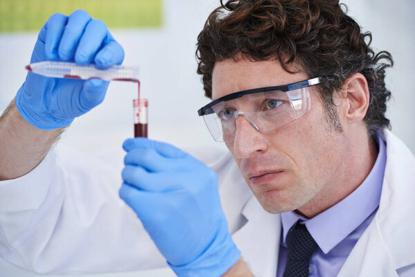 Science, study and man with blood in test tube for biotech engineering, pathology and analysis. Laboratory, investigation and scientist checking DNA sample for medical research in vaccine development.