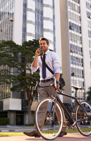 Bicycle, phone call and business man in city for travel, morning commute and walking to work. Professional, bike and person talk on smartphone for cycling, sustainable and eco friendly transport.