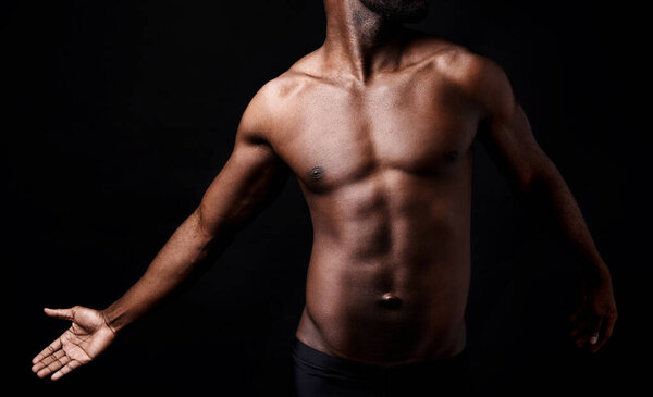 Black man, fitness and muscle with shadow for exercise or workout on a dark studio background. Closeup of young African male person or bodybuilder with masculine or muscular figure on mockup space.