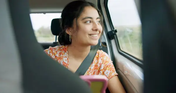 Woman, smartphone and road trip in car with laugh, meme and comic video on internet on road for travel. Girl, phone and reading in vehicle with funny blog, social media post or story with transport.