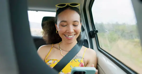 Woman, phone and texting on road trip, car or laugh at meme, comic video and internet for travel. Girl, smartphone and reading in vehicle with funny blog, social network post or story with transport.