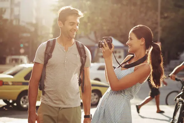 Couple, tourism and photography in street for travel, sightseeing and happiness on holiday or vacation in Brazil. Camera, man and woman with smile in city road for explore, tourist or journey in town.