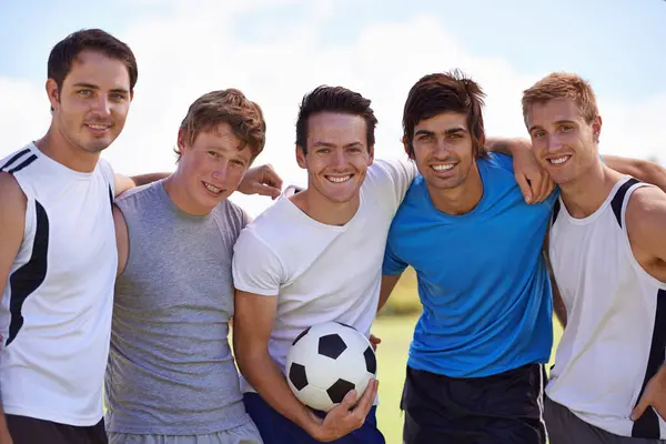 Soccer, men and together in portrait on field at game with fitness, exercise or happy with hug. People, teamwork and embrace with pride for support, solidarity or football with friends in competition.