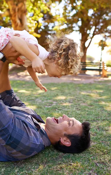 Plane, father and daughter with playing in park on grass for fun game, bonding and healthy relationship with energy. Happy family, man or girl child with airplane, childhood fantasy or flying outdoor.