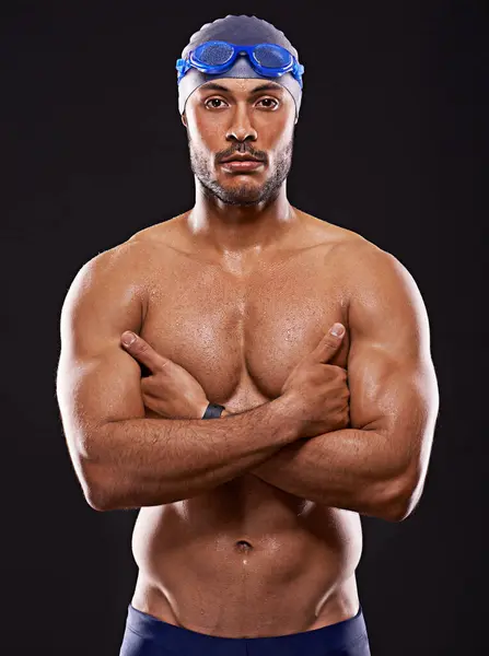 Studio, swimmer and portrait of man, strong and confident with health of body for competition. Professional, athlete and male person with aesthetic for sport, wellness and energy for training.