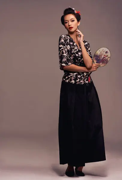 伝統的なスタイルとエレガントなスタイルで茶色の背景にスタジオに自信を持ってハンドミラーを持つポートレート アジアの女性とファッション 日本人 デザイナーの服装 — ストック写真