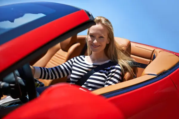 Woman, portrait and happy in sports car for adventure in summer or road trip on vacation in Beverly Hills. Luxury vehicle for speed on highway, transport and drive on mountain for journey or freedom.