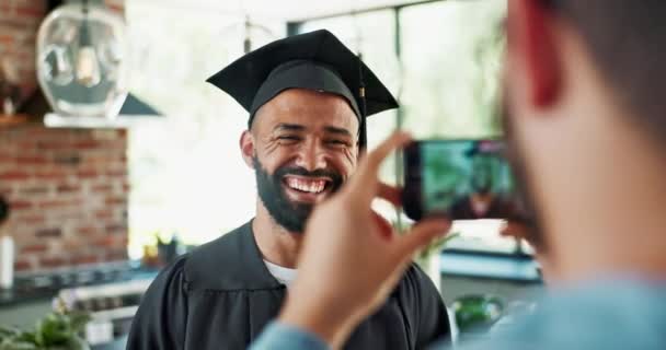 带着支持 学术成就和成功 在家里带着摄影的毕业 学生和欢笑 毕业了 男人和朋友都有电话庆祝 社交媒体或厨房里的回忆 — 图库视频影像