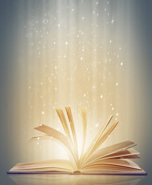 Magic, glowing pages and story with book, glitter and literature on a grey studio background. Empty, education and art with creativity and lights with novel and knowledge with astrology and sparkle.