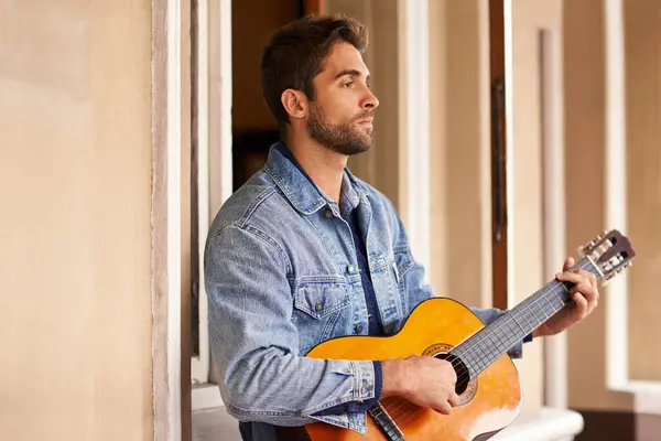Guitar, music and instrument for thoughtful male person, outside on patio or veranda. Acoustic, singer and talent for man musician for entertainment, enjoyment and pensive on holiday or vacation.
