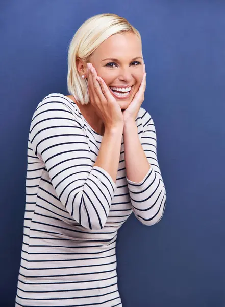 Happy, woman and portrait with confidence in fashion, style or creativity in studio on blue background. Girl, laughing and smile with pride as professional art director in business for project.