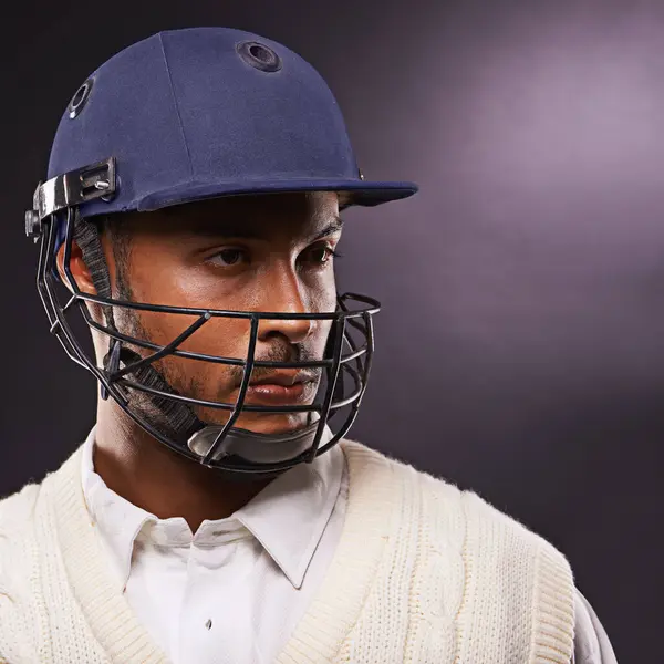 Man, cricket and athlete with sports helmet in studio for professional match, competition or black background. Male person, gear and exercise on mockup space for fitness training, performance or game.