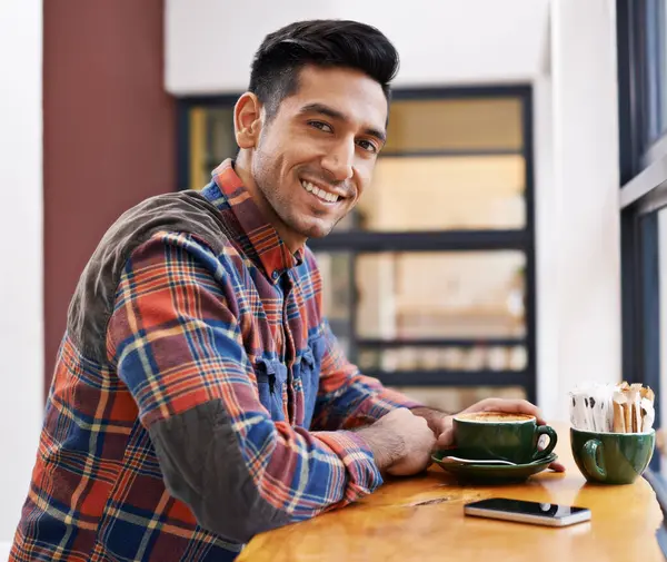 Happy man, portrait and coffee at cafe for morning, breakfast or drink at indoor restaurant. Young male person or freelancer with smile for latte, customer service or cappuccino at cafeteria or shop.