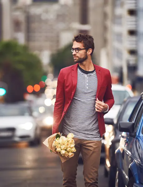 Fashion, flowers and urban for male person, city and street for walk or commute home. Autumn, trendy and contemporary style for man traveler in New York roads, cars and outdoor with roses bouquet.