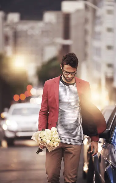 City, man and bouquet of flowers with walking for romance, love or kind gesture in New York. Male person, downtown and bunch of roses with idea for gift, planning or present on valentines day.