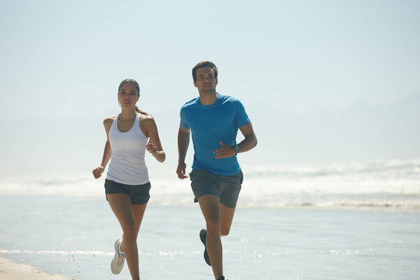 Cardio, beach and running with couple, training and summer with wellness and workout with morning routine. Seaside, energy or man with woman or runner with fitness and ocean with exercise or hobby.