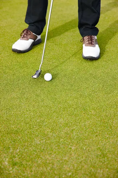 Feet, club and ball for sports on golf course, training and practice for competition or tournament. Closeup, shoes and grass for outdoor challenge and exercise, low angle and professional athlete.