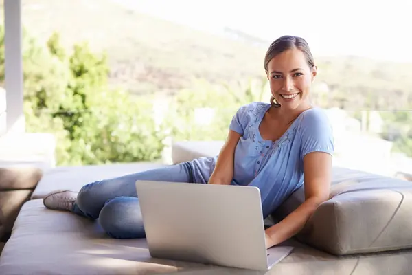 Nature, woman and laptop for relax, online and internet for streaming and research on vacation and rest. Young person and smile with tech on couch in outdoor for website or connectivity on holiday.