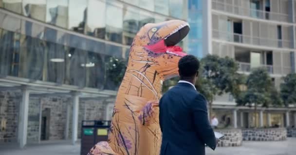 Inflatable Dinosaur Costume Man Outdoor Team Building Tablet Handshake Mascot — Stock Video