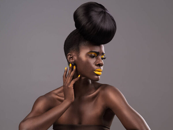 Beauty, makeup and black woman in studio with lipstick, cosmetics and eyeshadow on gray background. Creative, aesthetic and female model with yellow lip balm, nail polish manicure and cosmetology.