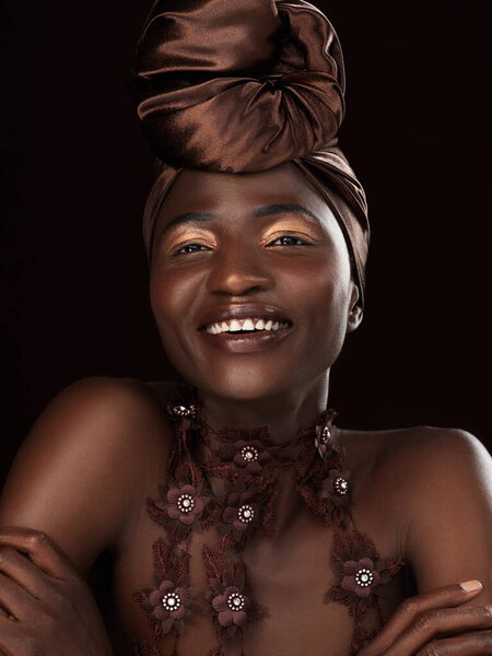 Happy, wrap and portrait of black woman in studio for cosmetics, natural beauty and makeup on dark background. Smile, glamour and African female model with traditional head scarf, eyeshadow and glow.