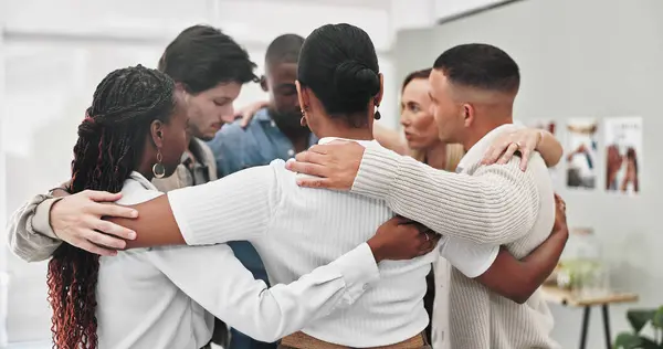 Group therapy, counseling and people hug in rehabilitation center for support, empathy or solidarity. Help, psychology and friends with safety prayer circle for trauma healing, gratitude or thank you.