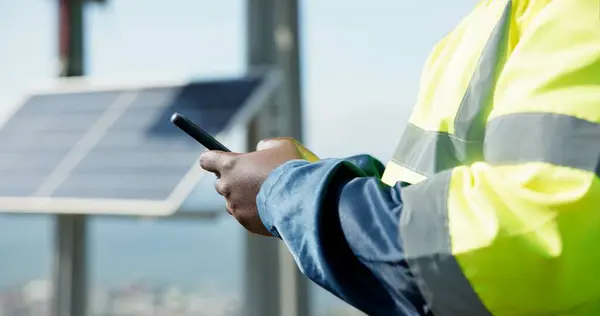 Man, phone and hands typing for social media, communication or solar panel research on rooftop. Closeup of person, contractor or technician on mobile smartphone for online networking or photovoltaic.
