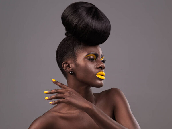 Aesthetic, makeup and black woman in studio with lipstick, cosmetics and eyeshadow on gray background. Creative, glamour and female model with yellow lip balm, nail polish manicure and cosmetology.