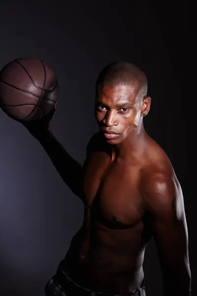 stock image Sportsman, studio and dark background or basketball or shirtless at night, sports or fitness or athlete. Black person, healthy and muscular with confidence for game or exercise, ball and strength.