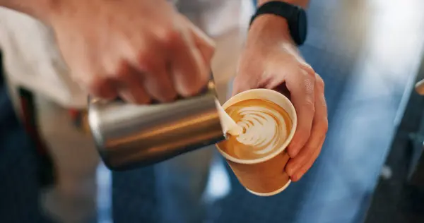 Latte art, coffee shop and hands pouring cup for take away with barista, small business and hospitality. Cappuccino, milk foam and service person in cafe, restaurant or bistro with hot drink to go