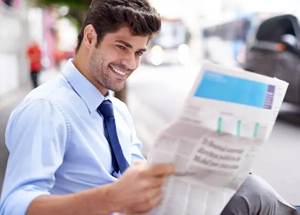Smile, businessman and reading newspaper for information, daily news and updates on local events. Professional, male person and outdoor with article for knowledge, stories and newsletter in city.