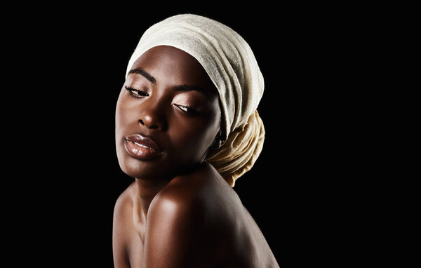Beauty, dark background and black woman with head scarf, natural makeup or creative aesthetic in mockup space. Art, skincare and African girl in studio with wrap, facial cosmetics and confidence