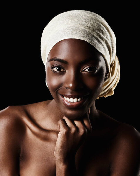 Smile, portrait and black woman with head wrap, natural makeup and creative beauty aesthetic in studio. Art, skincare and African girl on dark background with scarf, facial cosmetics and confidence