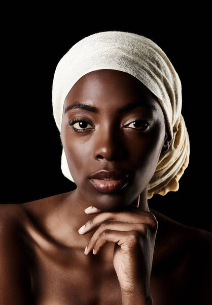Beauty, portrait and black woman with head scarf, natural makeup or creative aesthetic in studio. Art, skincare and traditional African girl on dark background with wrap, face cosmetics or confidence.