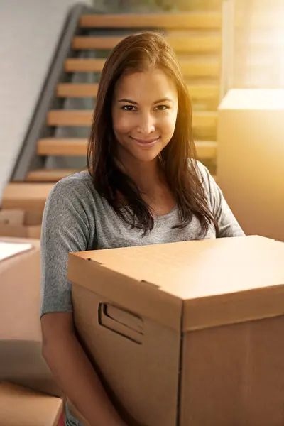 Woman, packing and boxes with portrait from delivery, carry or moving for new real estate and property. Cardboard, shipping and smile and happy homeowner with package and parcel by house stairs.
