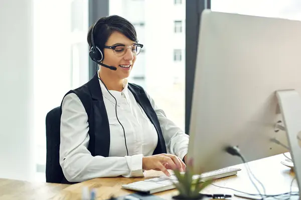 stock image Woman, computer and happy as employee at call center with customer or client support and service. Office, crm and advisor or consultant with confidence or satisfied on job and career growth as agent.