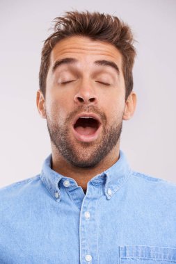 Man, eyes closed and yawn, tired in studio and burnout with facial expression and insomnia isolated on white background. Face, open mouth and fatigue with exhaustion, overworked and sleepless. clipart