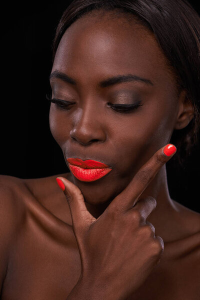 Black woman, lipstick and nail polish for beauty, cosmetics and bright makeup color on dark background. Bold, vibrant and orange lip balm with manicure, cosmetology and pose for glamour in studio.