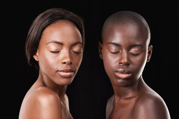 Studio, skin care and wellness of friends, cosmetics and foundation on black background. Sisterhood, African women and together for dermatology or facial treatment, confidence and proud of glow.