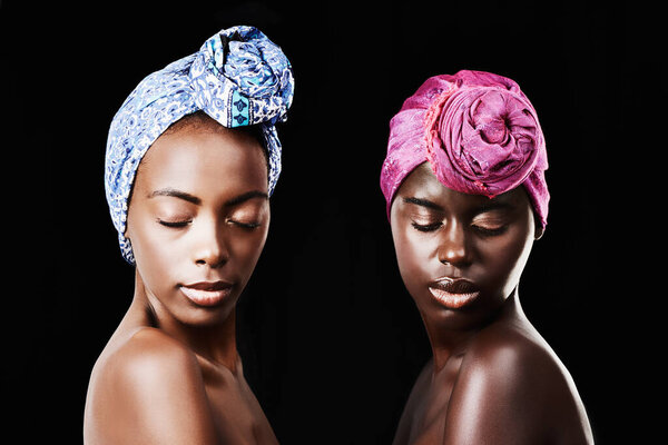 Black women, head wrap and relax portrait with beauty, skincare and natural cosmetics in studio. Traditional, turban and African fashion with wellness and skin glow with makeup and dark background.