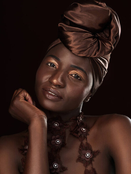 Portrait, wrap and black woman in studio for glamour, natural beauty and eyeshadow on dark background. Cosmetics, makeup and African female model with traditional head scarf, skincare or aesthetic.