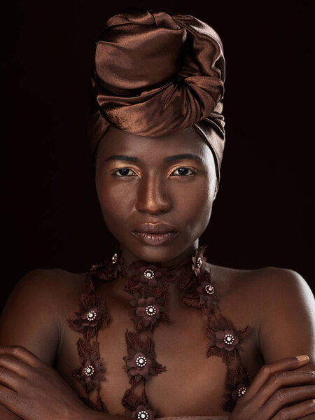 Turban, portrait or African woman with makeup, arms crossed or pride in studio on black background. Glow, face and serious model with beauty, eyeshadow cosmetics and fashion for culture tradition.