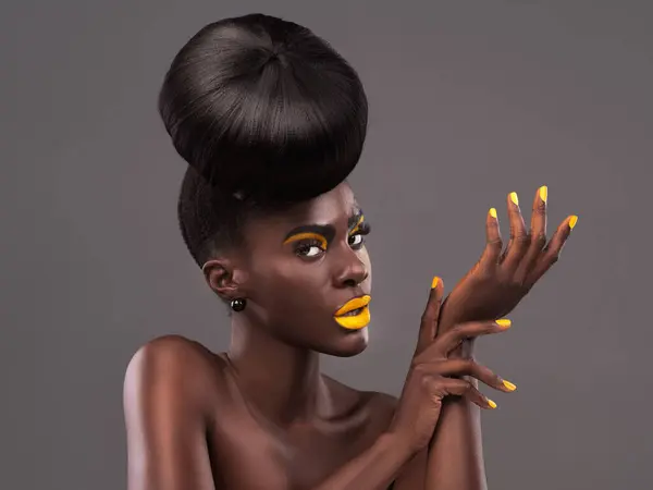 African, model and style portrait for makeup, beauty and creative yellow lipstick. Bold, woman or skin with confidence, dramatic hair and bun for glamour or trendy cosmetics on grey studio background.