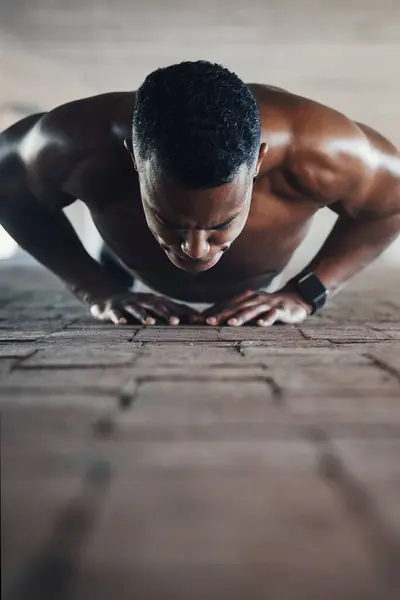 Black man, fitness and cardio with push ups on floor for training, exercise and endurance in Atlanta. Sweating, bodybuilder and resilience in workout with energy for body strength, self care or power.