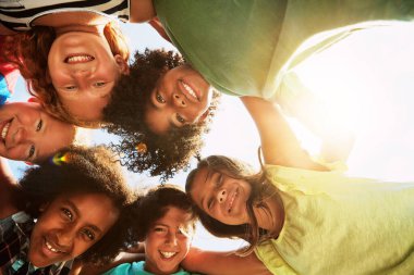 Happy, huddle and portrait of kids in park for bonding, playing and fun together outdoors. Diversity, youth and low angle of children hug in circle for childhood, friendship and relax on weekend. clipart