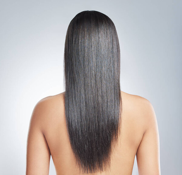 Hair, back and woman in studio with wellness, cosmetics and shampoo treatment, shine or results on grey background. Haircare, beauty and behind girl model with texture style, glow and growth progress.