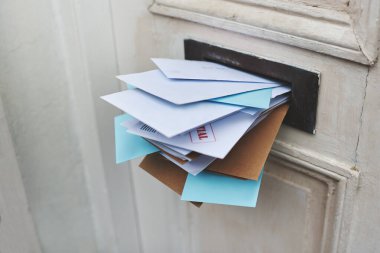 Door, letter and mail or envelope in box of home for communication or notice, stacked and overflowing with documents. Mailbox, post and address for mortgage or debt, message and paper from bank clipart