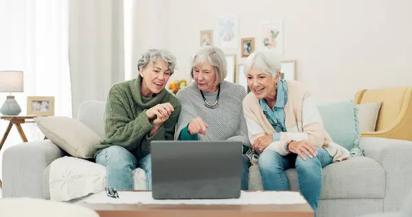 stock image Laptop, friends and senior women on sofa online for social media, streaming movies and internet search. Retirement home, social reunion and caregiver on computer for learning, teaching and helping.