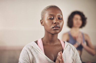 Black woman, namaste and peace for meditation with yoga for holistic wellness, mental health and healing in class. Girl, person and prayer hands for mindfulness, stress relief or zen with eyes closed.